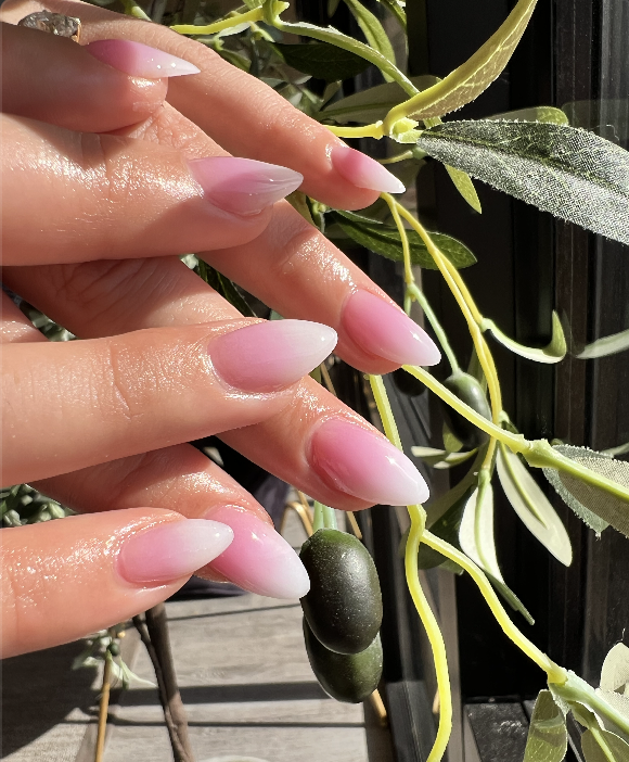 Pink ombré almond nails in natural light